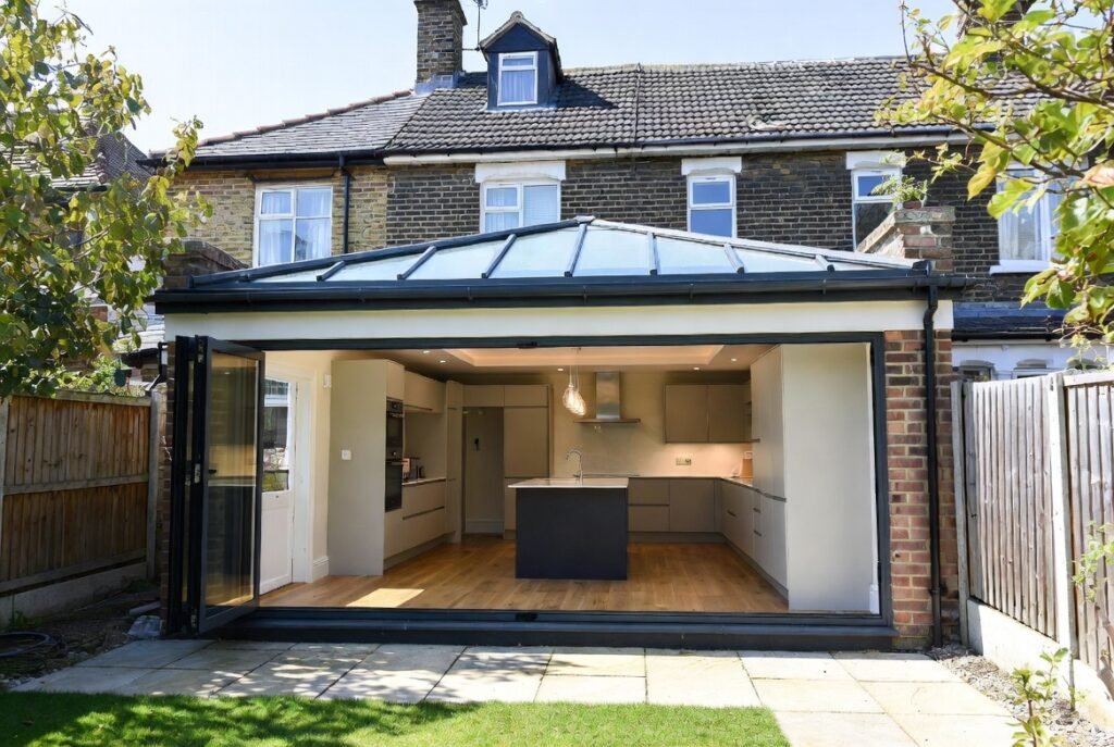 Single storey rear kitchen extension Croydon with full-width bi-fold doors, roof lantern and open-plan kitchen design
